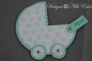 a baby carriage shaped card with buttons on it