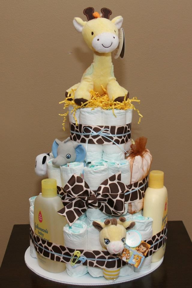 a giraffe themed diaper cake on a table