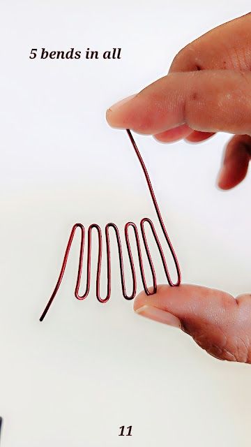 a person is holding a small wire in their hand