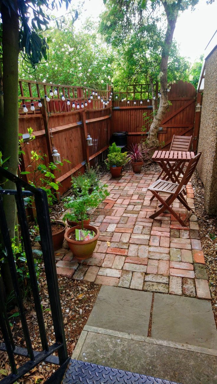 an outdoor patio area with chairs and plants