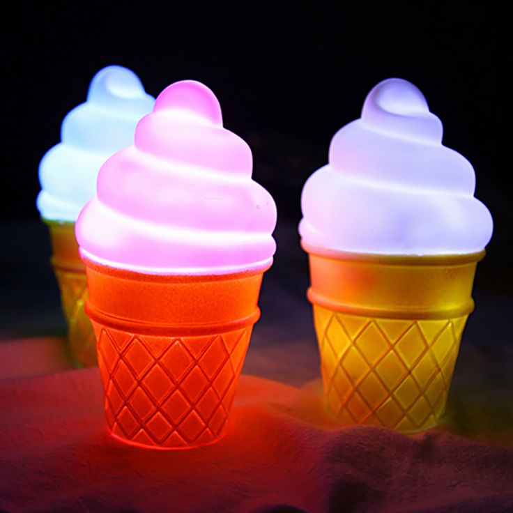 three ice cream cones sitting on top of a table