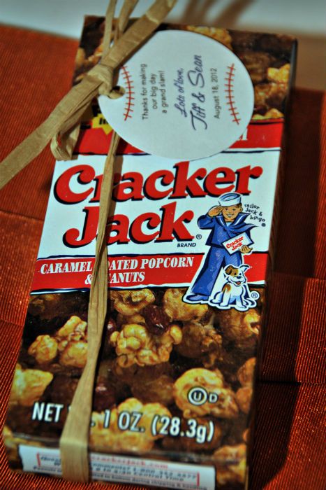 a package of cracker jack popcorn tied up on a table with a tag attached to it