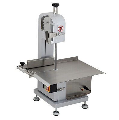 a machine that is sitting on top of a white surface with wheels and nozzles