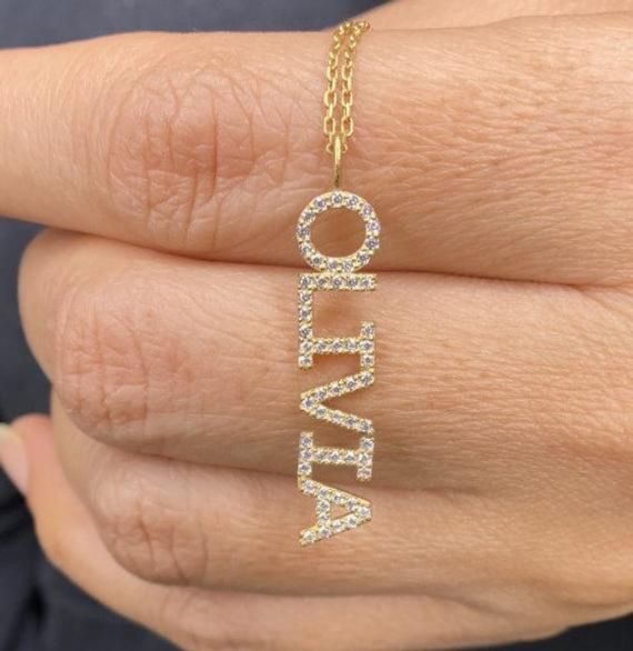 "This 14k personalized diamond name necklace is the perfect gift for the bridal party, someone special, or yourself. * All letters are capital. M A T E R I A L & L E N G T H Available in 14k Yellow Gold, 14k Rose Gold, 14k White Gold, Sterling Silver Thickness: 1.2mm / 0.05\" Initials Lowercase: 4 mm Capital: 8 mm Diamond: 0.10 ct. - 0.30 ct. depending on the name Color: G Quality: SI-VS Additional Notes: * Non-Conflict Diamonds * Made in the USA C U R R E N T ∙ T U R N A R O U N D Processin Diamond Necklace For Mother's Day Personalized Gift, Luxury Nameplate Necklace For Personalized Gift, Luxury Personalized Name Necklace As A Gift, Luxury Personalized Name Necklace As Gift, Luxury Custom Name Necklace For Gift, Luxury Personalized Name Necklace For Gift, Luxury Personalized Nameplate Necklace, Personalized Diamond Necklace For Birthday, Personalized Diamond Jewelry For Birthday Gift