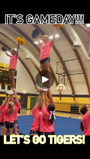 a group of girls in pink shirts doing tricks on a basketball court with the words let's go tigers