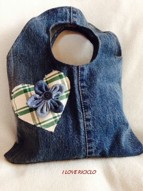 a bag made out of jeans with a flower on the front and a heart in the back