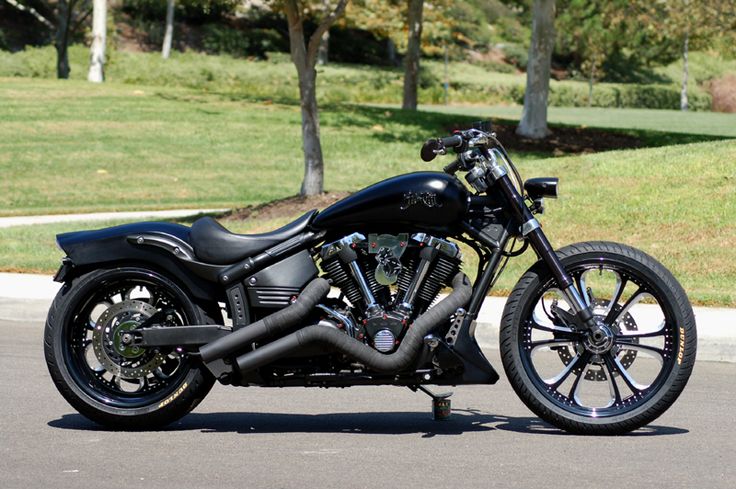 a black motorcycle is parked on the street