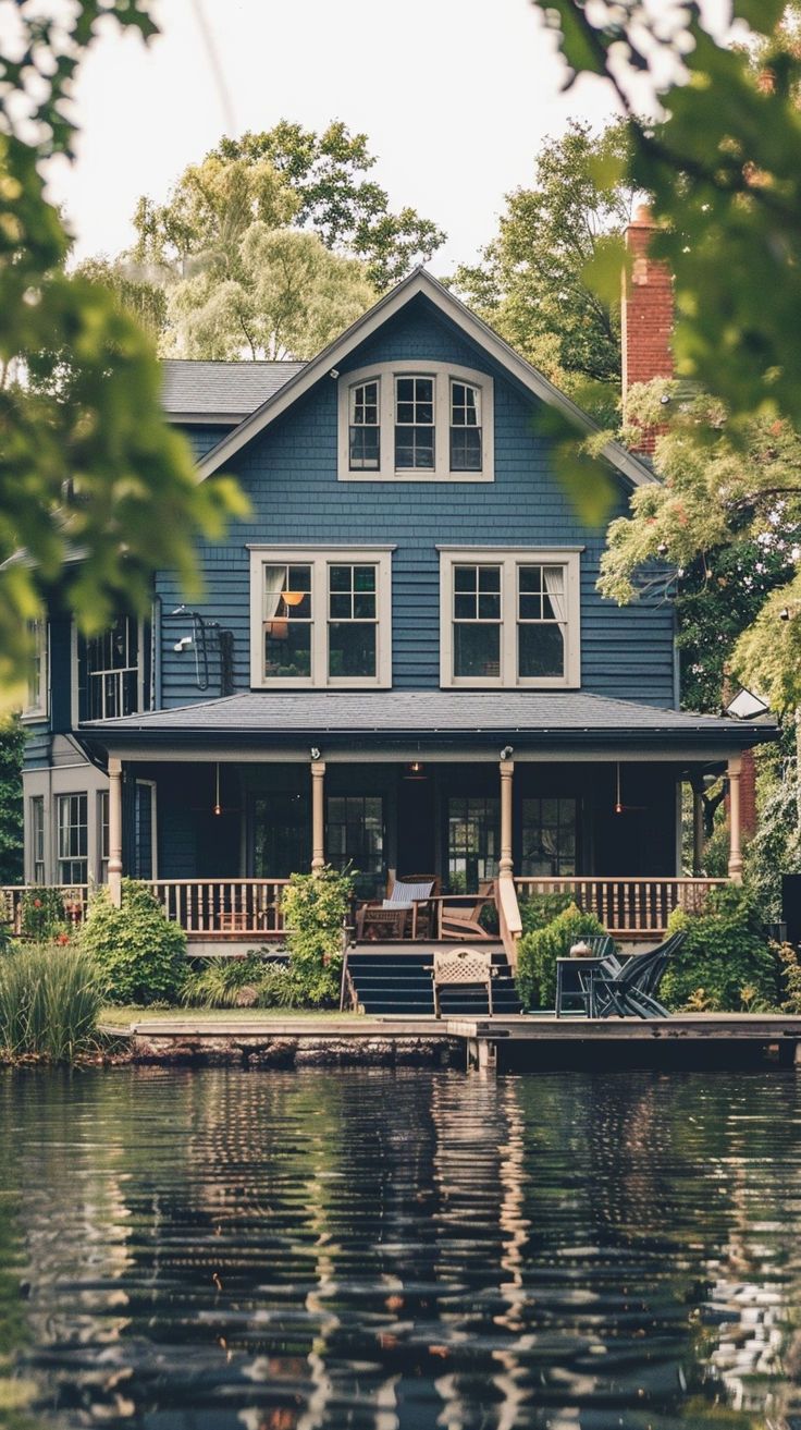 a large blue house sitting on top of a lake