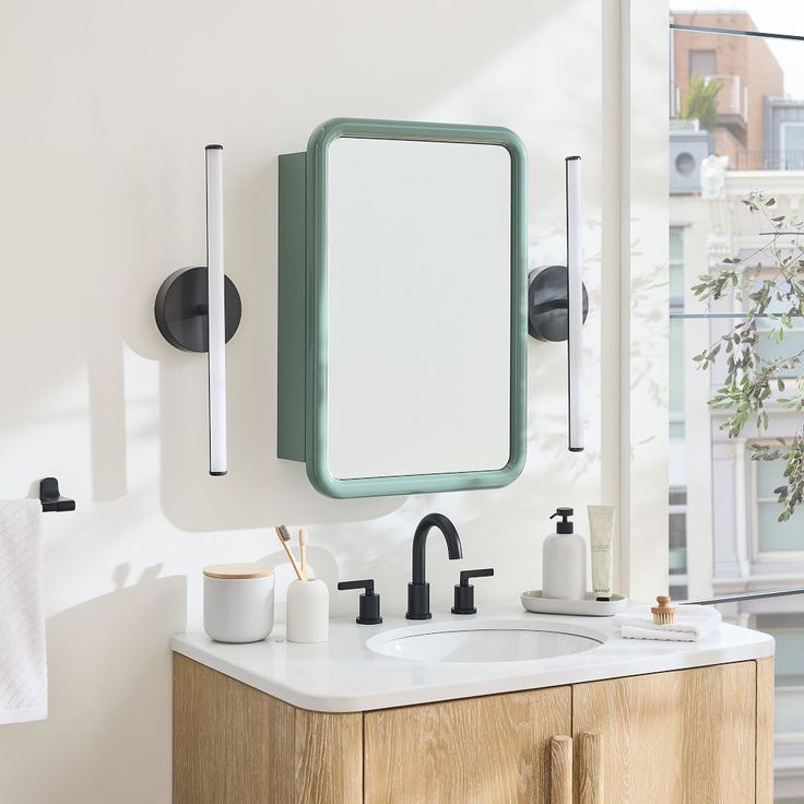 a bathroom sink with a mirror and soap dispenser