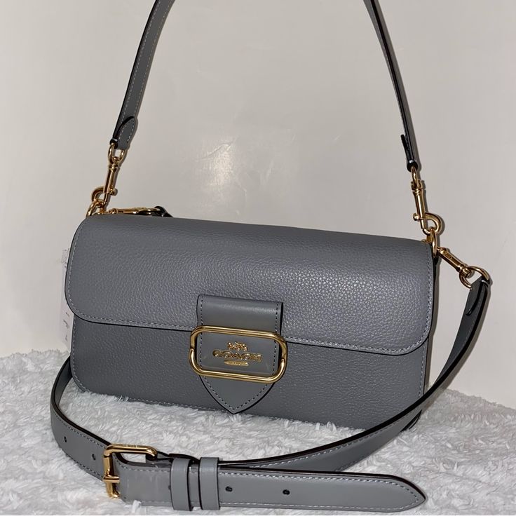 Coach Morgan Shoulder Bag New 100 % Authentic New With Packaging Granit Color With Gold Hardware Refined Pebble Leather Smooth Leather And Suede Snap Closure Handle With 9" Drop Strap With 21 1/4" Drop Included Approximately Measurements 10 1/2" L X 5 1/2" H X 2 1/2" W Smoke And Pets Free Classic Gray Bags With Gold-tone Hardware, Designer Gray Bag With Removable Pouch, Luxury Everyday Gray Satchel, Luxury Gray Everyday Satchel, Classic Gray Top Handle Bag, Luxury Gray Satchel Bag, Designer Gray Shoulder Bag, Gray Satchel Shoulder Bag With Detachable Strap, Classic Gray Satchel Bag