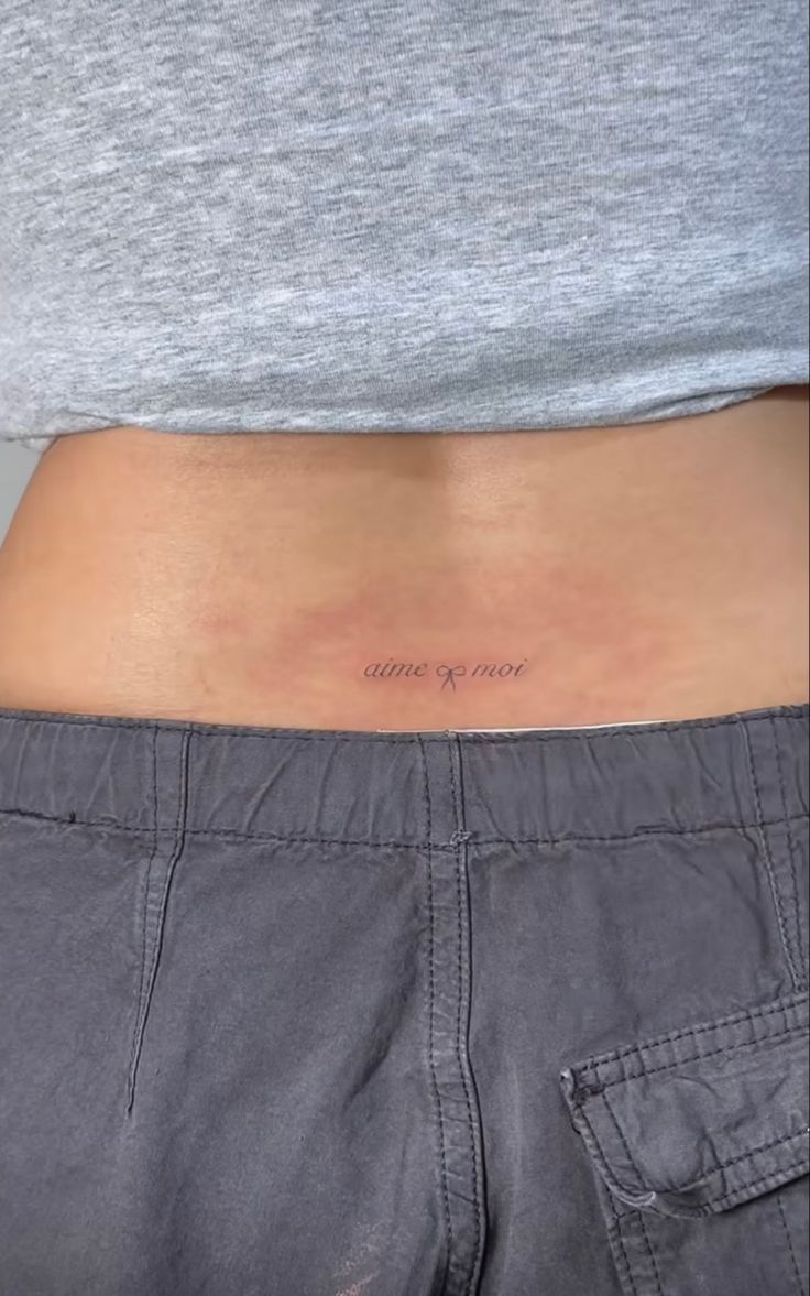 a person with a small tattoo on their stomach