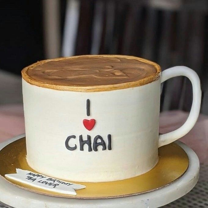 a coffee cup with the word i love chai on it sitting on a saucer