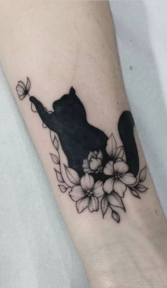 a black cat with flowers on its leg