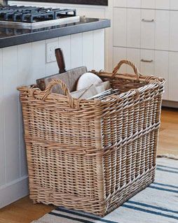 a kitchen with an oven, stove and basket on the floor in front of it