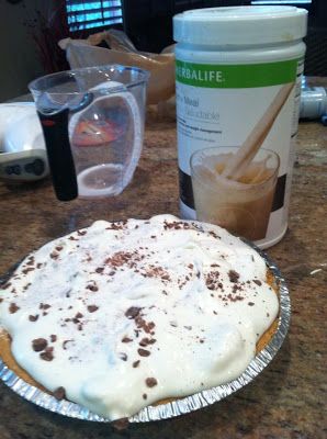 a cake sitting on top of a counter next to a jar of liquid and a shaker