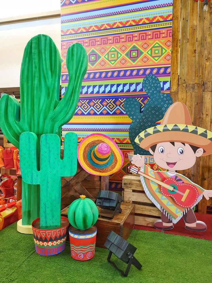 an inflatable cactus and sombrero are on display at a mexican themed party