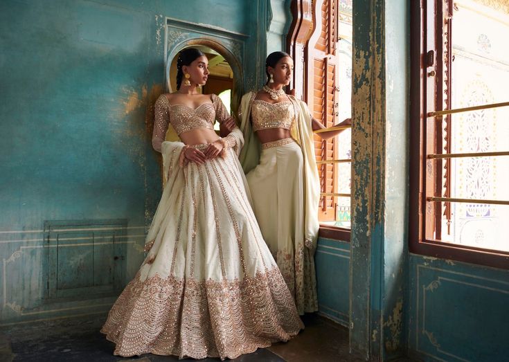 A stunning off-white lehenga with a gold embroidered blouse and skirt bottom.From Bindani’s Rang Mahal collection DELIVERY TIMEPlease allow 8-12 weeks for your outfit to arrive. FABRIC DETAILSHabutai silk Professional cleaning only. Elegant Off-white Sharara With Pallu, Elegant Off White Sharara With Pallu, Elegant Cream Sharara For Navratri, Elegant Off-white Lehenga For Festive Occasions, Elegant Off White Designer Choli, Elegant Cream Choli For Designer Wear, Elegant Off White Choli For Festive Occasion, Elegant Off-white Designer Choli, Elegant Off White Festive Choli