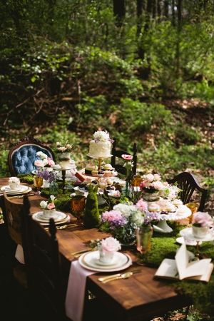 an image of a table set with flowers and cake