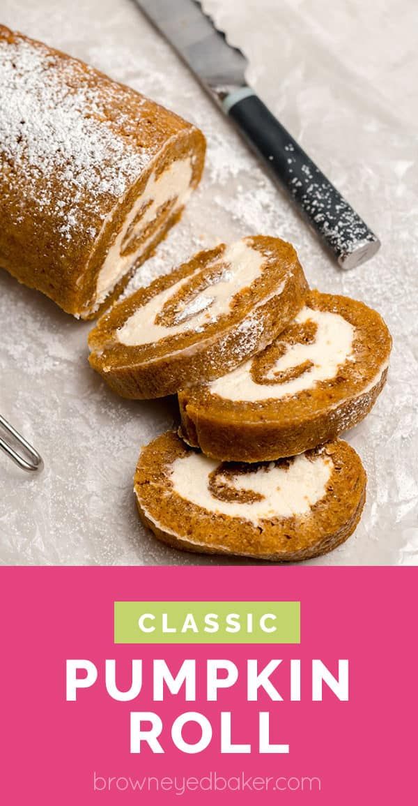 pumpkin roll with cream cheese frosting on top and sliced in half next to knife