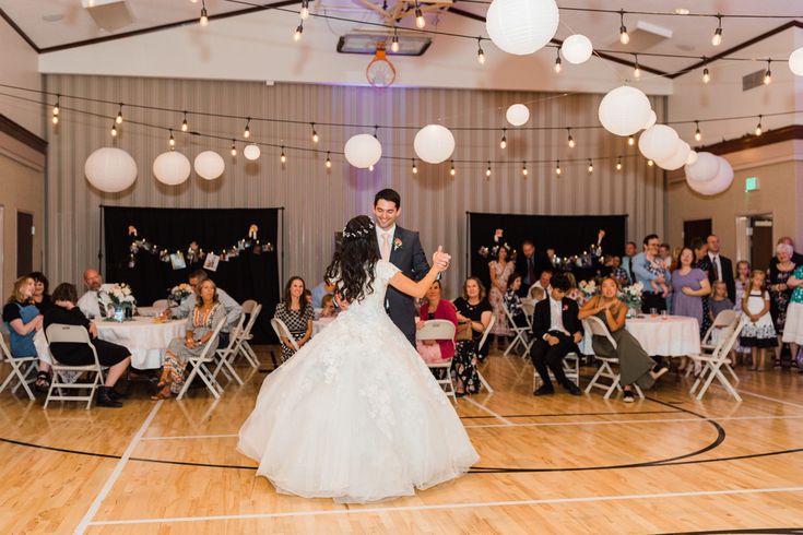 the bride and groom are dancing on the dance floor