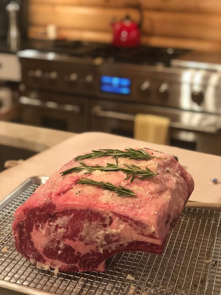 a piece of raw meat sitting on top of a metal rack