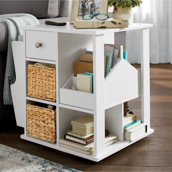 a white table with baskets and books on it