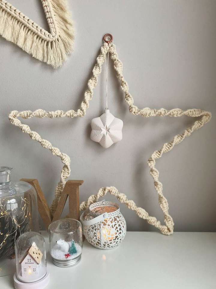 a white star hanging on the wall next to other decorations and decorating items in front of it