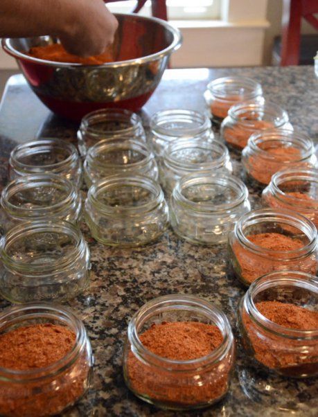 several jars filled with spices on top of a counter