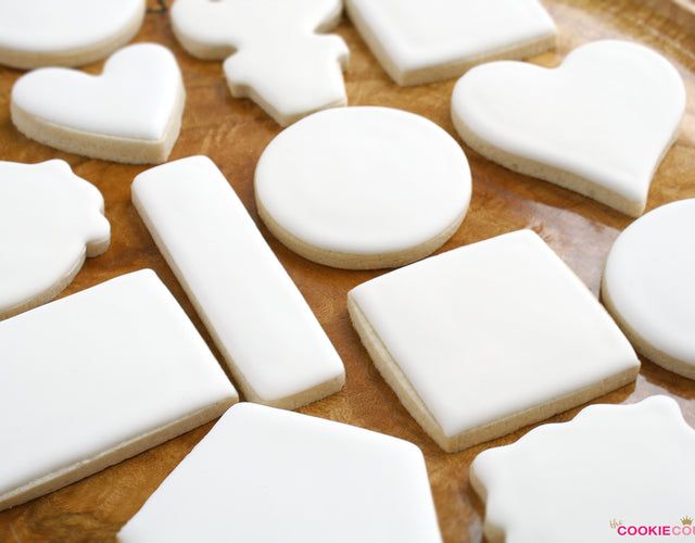 some white cookies are sitting on a table