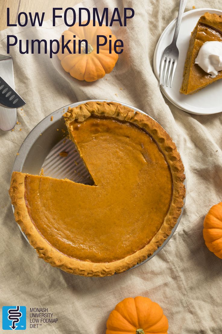 there is a pie on the table with pumpkins around it and a fork next to it