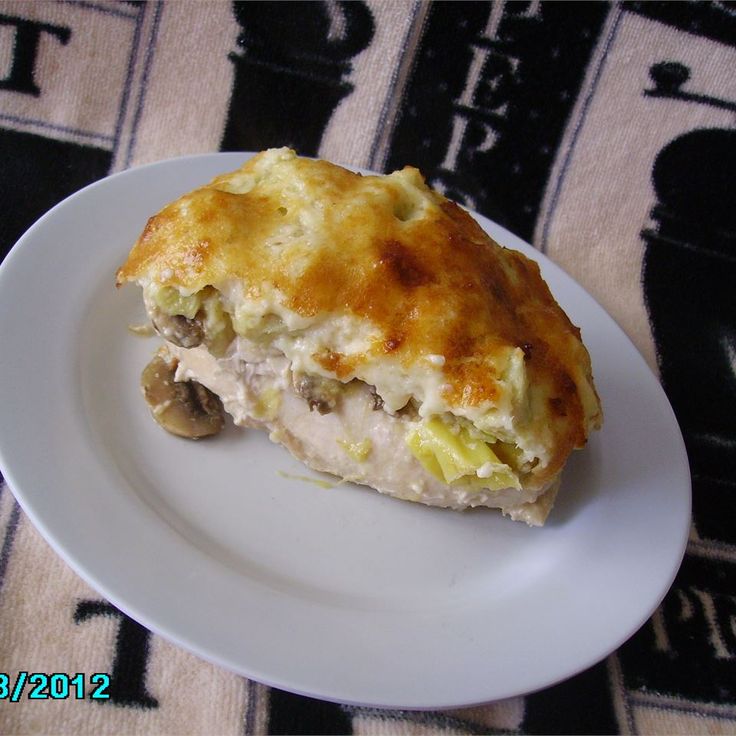 a piece of food on a white plate with a black and white checkered table cloth