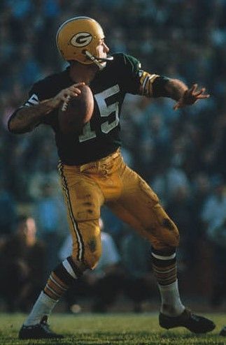 a football player is running with the ball in his hand and people are watching from the stands