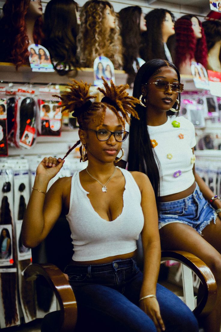 two women sitting in chairs with hair on their heads