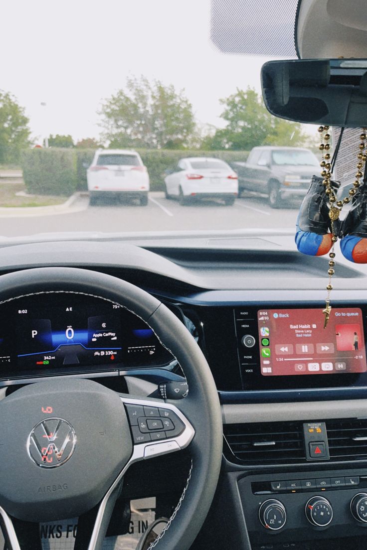 the interior of a car with dashboard lights, steering wheel controls and electronic display screen