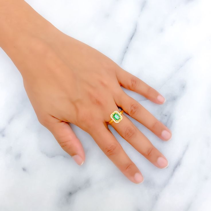 This 22k gold ring, weighing 3.2 grams, boasts a gorgeous green cubic zirconia solitaire, exuding an aura of elegance and charm. The yellow gold finish impeccably complements the verdant hue of the stone, adding a touch of warmth. Available in size 8 with the option for resizing, this ring is perfect for those who adore the luxurious interplay of vibrant color and the timeless allure of gold, offering a distinguished and captivating presence. PRODUCT DETAILS Gold Purity(karat): 22k Item Weight(g 22k Gold Green Jewelry For Anniversary, Green 22k Gold Jewelry For Anniversary, Classic Gold Ring With Tsavorite, 22k Yellow Gold Emerald Ring, Fine Jewelry Green Diamond Ring For May Birthstone, Green Diamond Topaz Ring, Green Topaz Ring With Diamond Accent, Green Topaz And Diamond Anniversary Ring, Green Topaz Diamond Ring For Anniversary