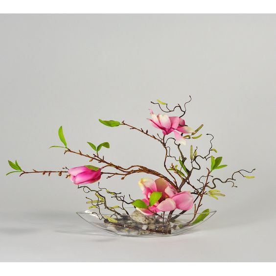 a vase filled with pink flowers on top of a table