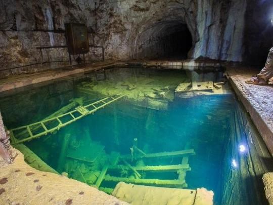 an underground swimming pool with stairs leading to it