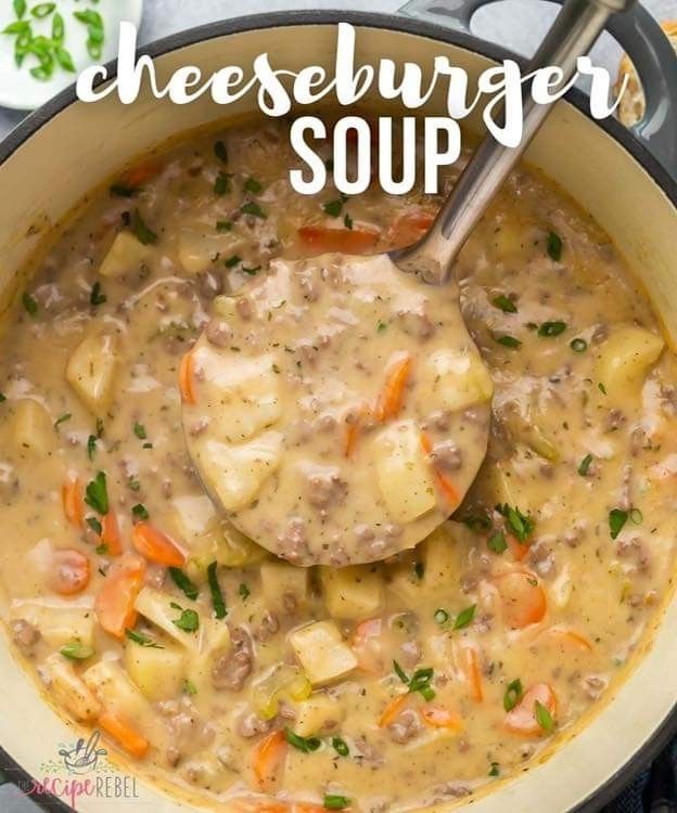 a bowl filled with cheeseburger soup on top of a table