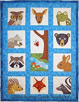 a quilted wall hanging with animals on it