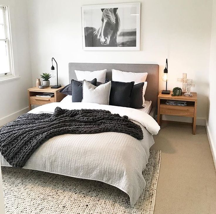 an instagramted photo of a bedroom with black and white decor on the walls