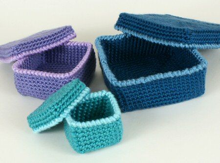 crocheted baby shoes and booties sitting next to each other