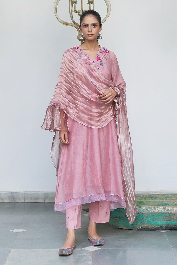 Plum chanderi kurta with 3D organza flowers on the yoke panel in a V-neck. Complemented with a tissue dupatta and hand embroidered pants.
Component: 3
Embroidered
Neckline: V-Neck
Sleeve Length: Three Quarter
Fabric: Kurta: Chanderi; Pant: Cotton; Lining:  Cotton; Dupatta: Tissue
Color: Pink, Purple
A-line silhouette kurta
Attached cotton lining kurta
3D organza tissue flowers, hand embroidery and bullion knots across the yoke
Floral hand embroidered pant
Side slit kurta
Asymmetric hem kurta - A Beige Kurta, Purple Embroidery, Fancy Fits, Kurta Set For Women, Latest Dress Design, Kurti Designs Latest, Kurti Embroidery Design, Fashion Sketches Dresses, Kurta Designs Women