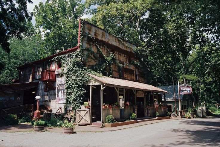 an old building with vines growing on it's side in front of some trees