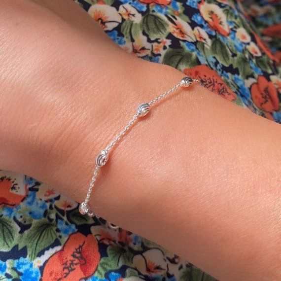 Silver Minimalist Dainty Beaded Design Bracelet,  a truly beautiful dainty bracelet which would compliment any outfit. GOOD TO KNOW: We also make this same design as a necklace, please message us and we will assist if its the necklace you would like. TO SHOW OUR APPRECIATION WE HAVE A XMAS GIFT FOR YOU - VISIT OUR SHOP TO FIND YOUR GIFT - FLAWLESS EDGE X *   Metal: Rhodium Plated 925 Sterling Silver ( Rhodium is a form of Platinum, helps resist scratches and adds durability to your jewellery ) *   Design: Elegance, Dainty, Minimalist *   Width: Approximately 4-5mm diameter - widest points *.  Length: 7.5 Inches - Standard UK length to fit most wrist sizes. XS, S, M.  Don't forget to hit 'favourite' on the right so it remains in your favourites list and/or to your wish list(s).  Customised Bracelet Aesthetic Simple, Silver Bracelet Aesthetic, Minimalistic Jewelry, Bracelet Layering, Bracelets Design, Bracelet Minimalist, Design Bracelet, Dainty Bracelet, Daisy Earrings