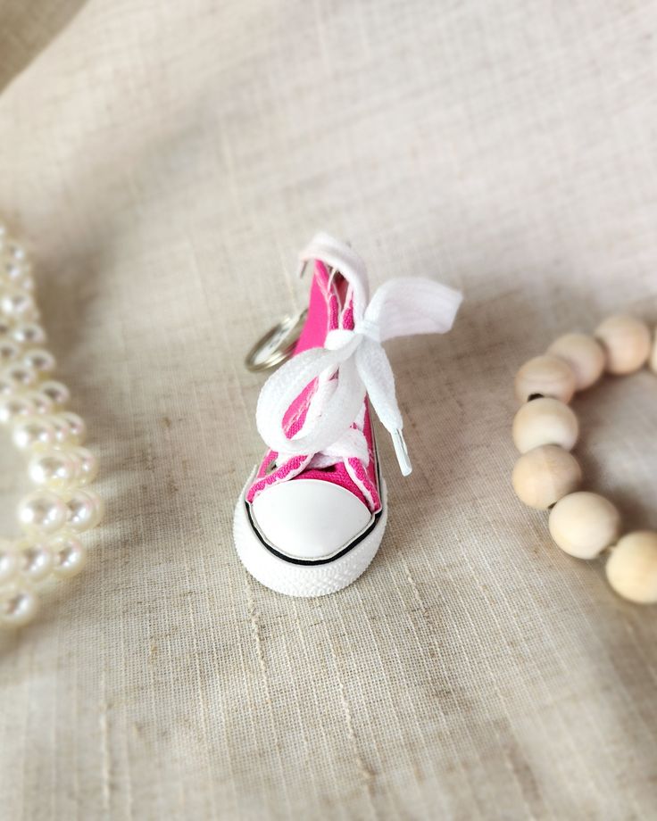 Add some sneaker style to your keychain with our Converse Shoe Keychain! This quirky accessory is perfect for any sneakerhead and makes a fun statement piece. Never lose your keys again with this playful and functional keychain. Sneaker Key Chain, Casual Pink Sneakers For Gift, Casual White Keychains With Key Leash, Casual White Keychain With Key Leash, Trendy White Keychain With Key Leash, Shoe Keychain, Sneaker Style, Sneaker Head, Sneakers Fashion