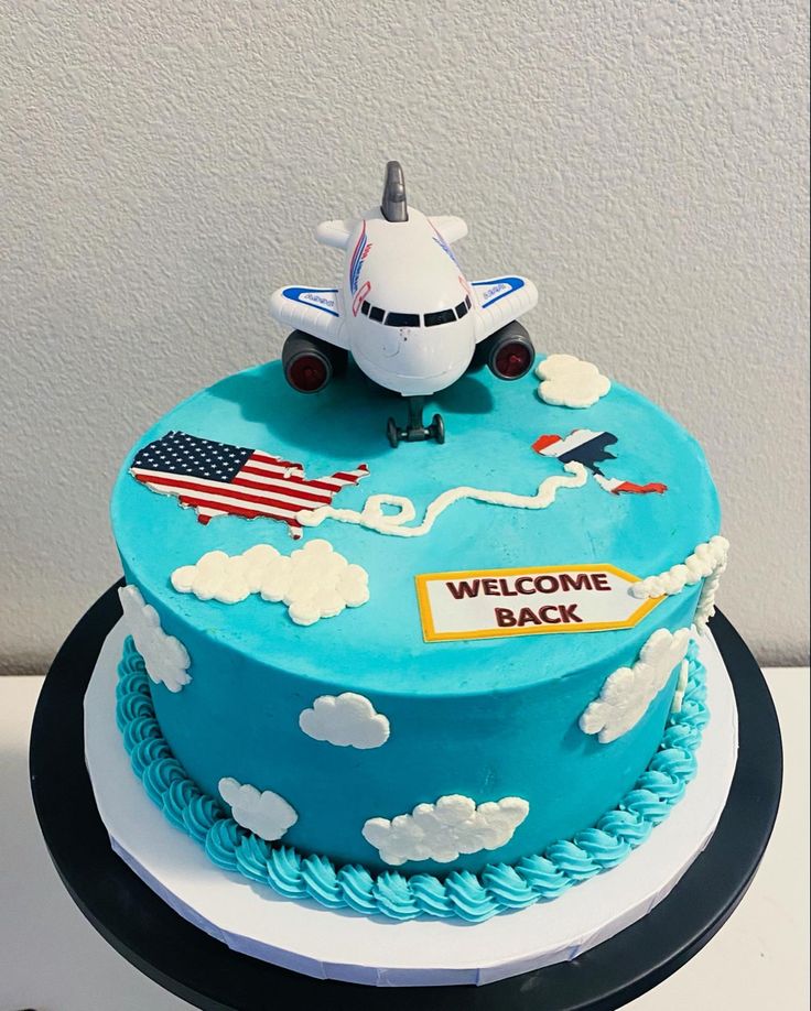 a cake decorated with an airplane and the words welcome back