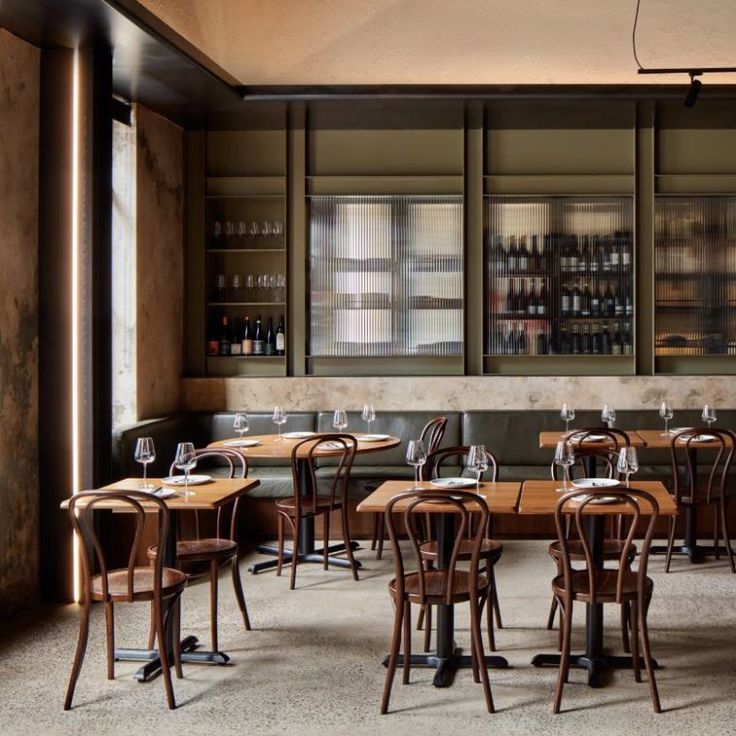 an empty restaurant with wooden tables and chairs