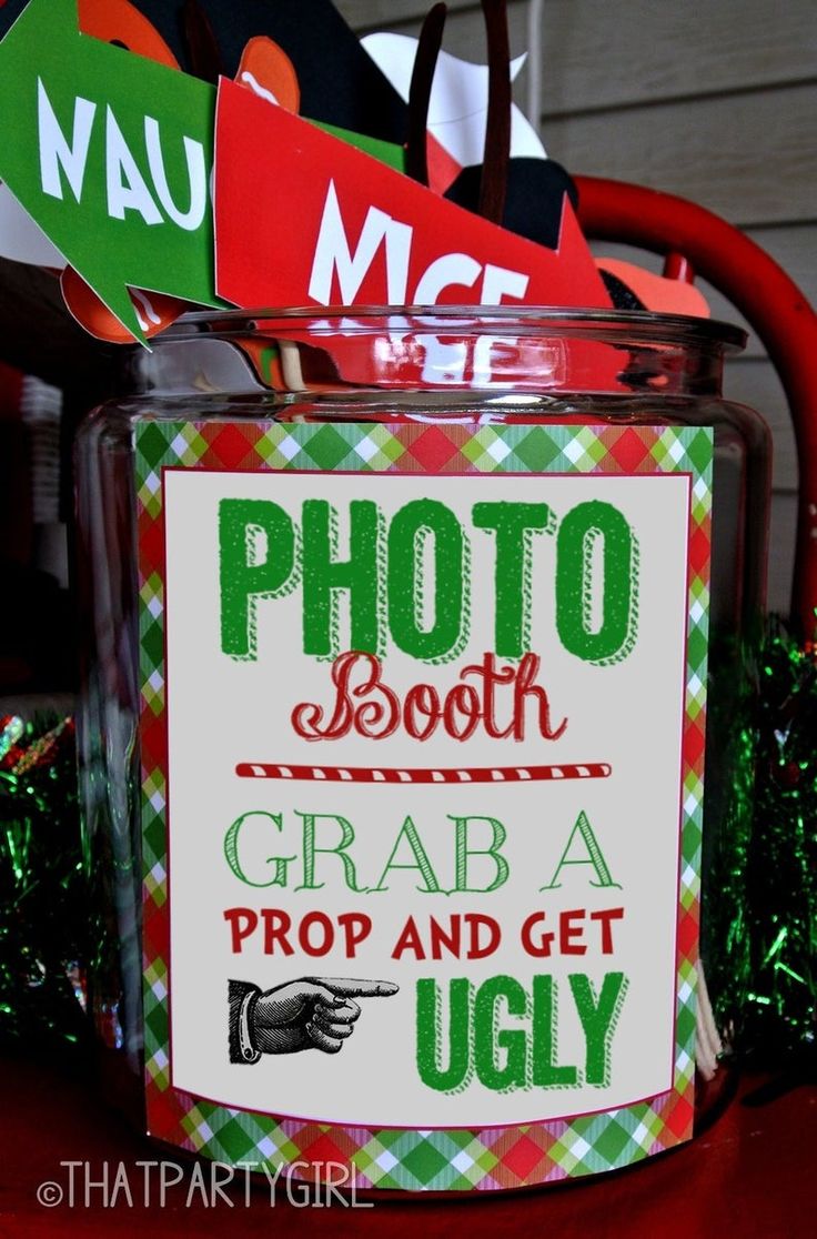 a glass jar filled with candy canes sitting on top of a red and green table