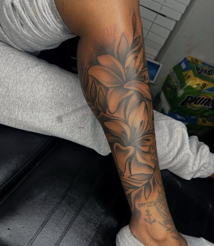 a man with a flower tattoo on his arm