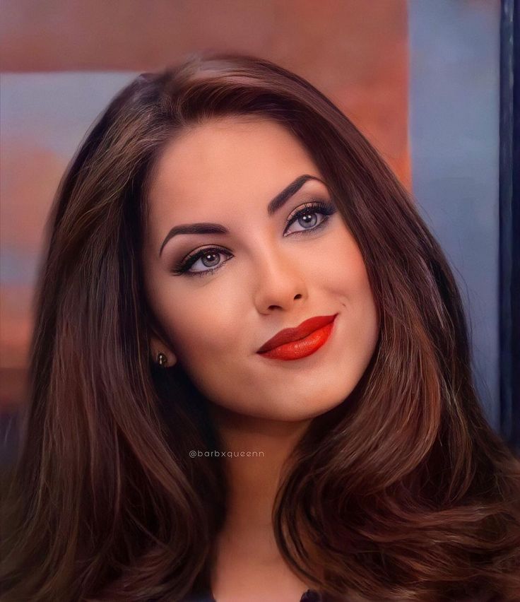 a woman with long brown hair and red lipstick